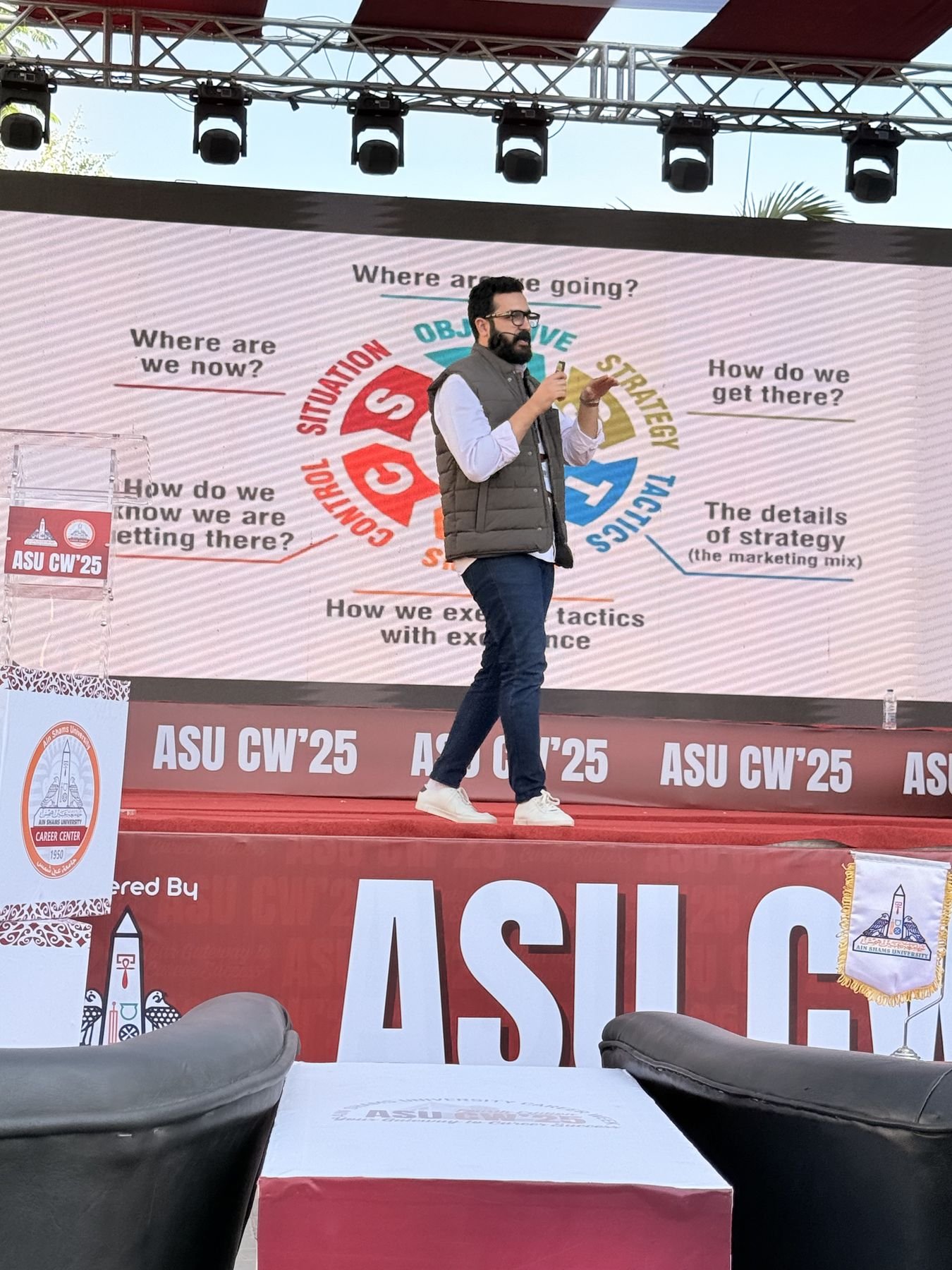 Eslam Toba speaking on stage with a microphone