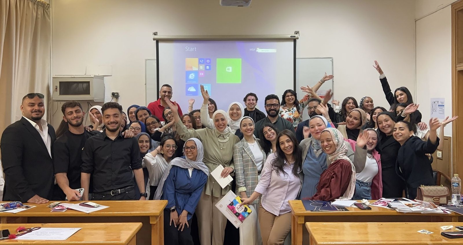 University students cheering with Eslam at the end of a workshop