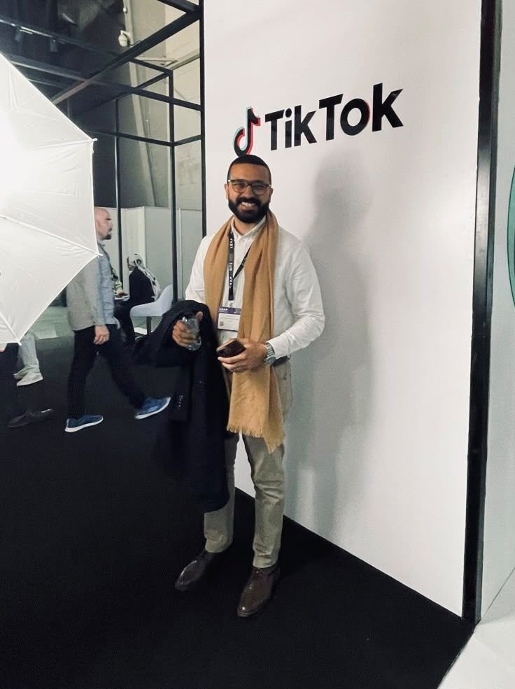 Eslam Toba at a TikTok event in front of the TikTok wall